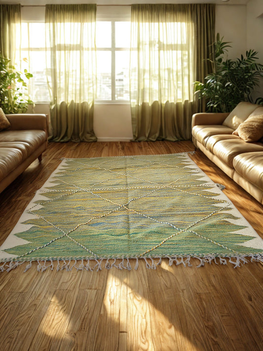 Living room with a green and white patterned rug, beige sofa, and green curtains.