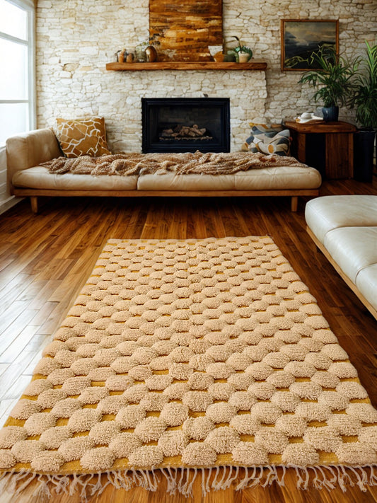 Beige textured rug on a wooden floor with a living room in the background