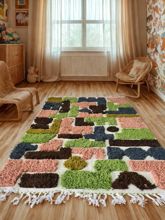 Colorful geometric-patterned rug on a wooden floor with wicker furniture and curtains in the background.