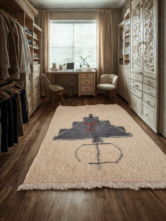 Room with a rug featuring a design on a wooden floor.