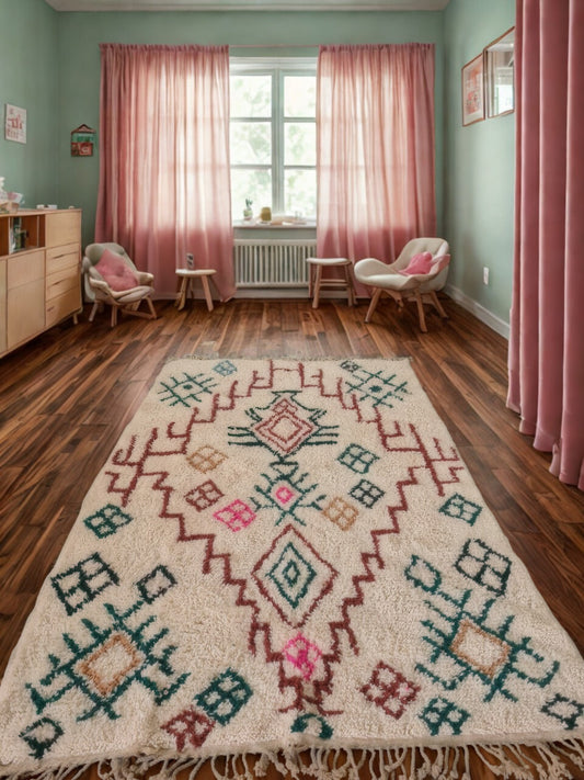 Room with pink curtains, a patterned rug, and wooden furniture.