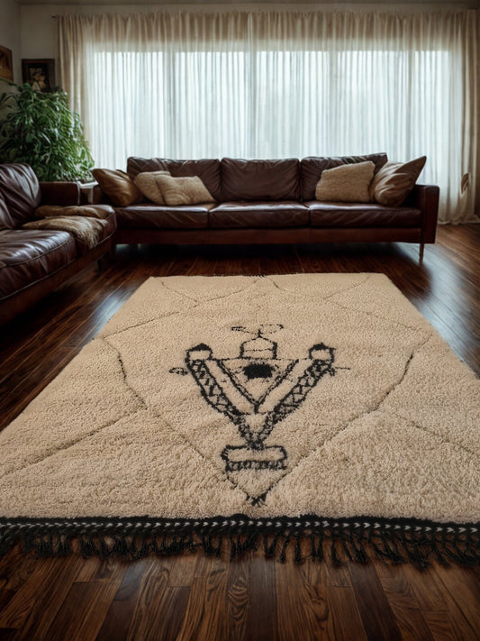 Brown leather sectional sofa in a living room with a decorative rug featuring a geometric design.