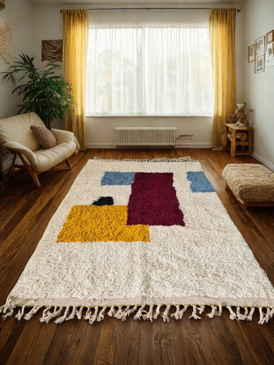 Colorful geometric-patterned rug on a wooden floor with a window and curtains in the background.