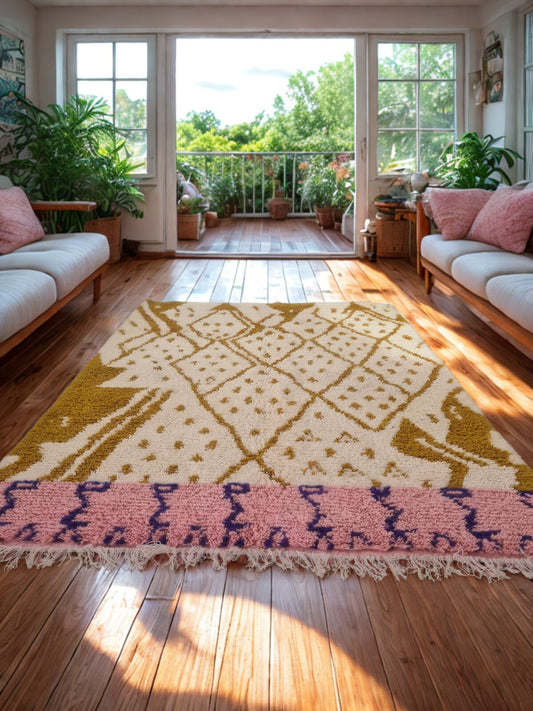 Living room with a patterned rug, couches, and a view of a balcony.